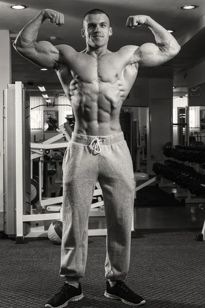 Handsome muscular guy in the gym