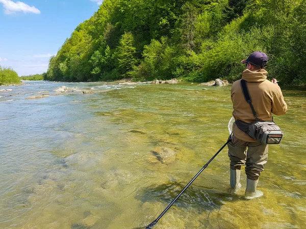 Fishing on the mountain river. Trout fishing. Fisherman fishing