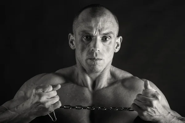 Very muscular handsome athletic man on black background