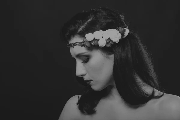 Pretty brunette with a wreath in her hair, black-and-white photo