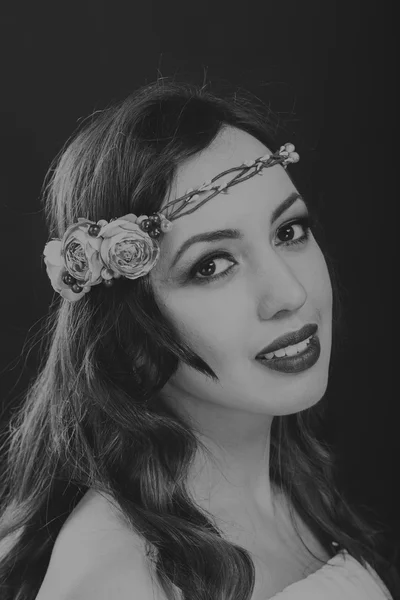 Black and white portrait of a beautiful girl in a wreath