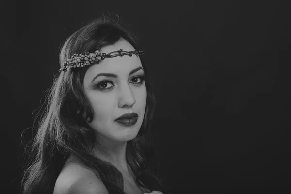 Black and white portrait of a beautiful girl in a wreath