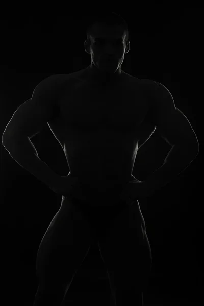 Elegant, muscular male body on black background