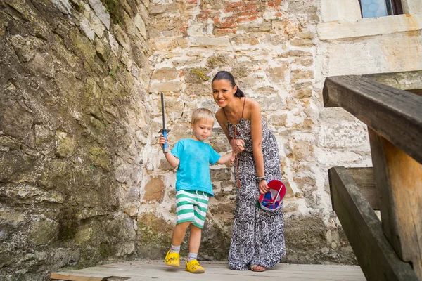 Mom and son on stairs of medieval fortress