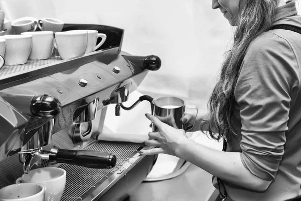 Girl makes coffee using coffee machine.