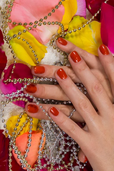 Manicured hands with red nail polish