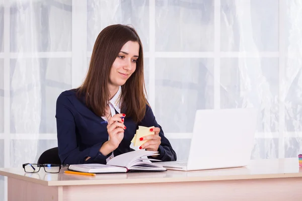 Businesswoman with laptop in office.