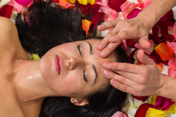 Young woman receiving facial mask