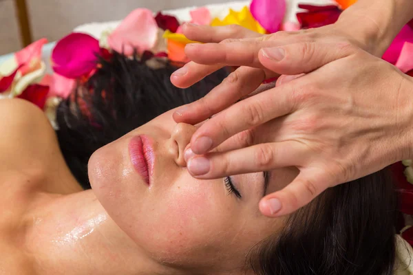 Young woman receiving facial mask