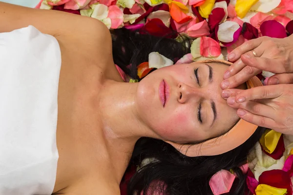 Woman receiving facial massage