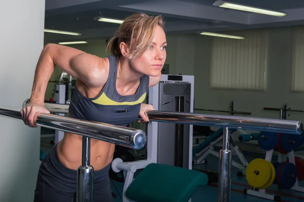 Woman doing exercises in gym.