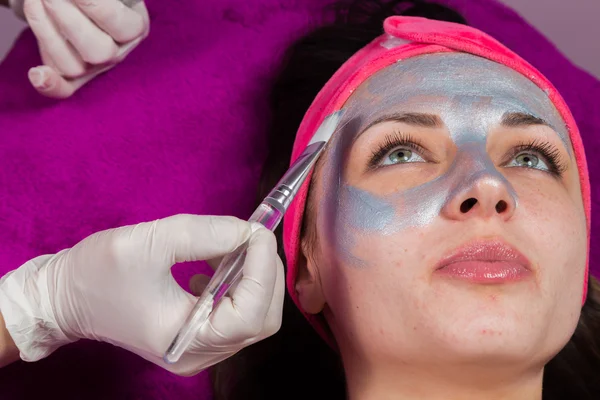 Makeup artist applies invigorating mask