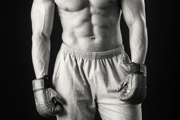 Athletic man in boxing gloves