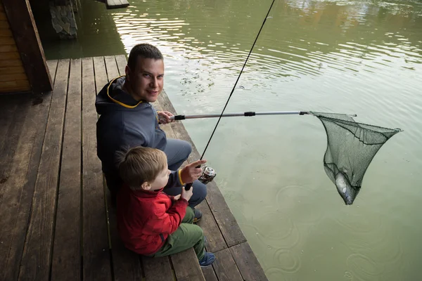 Father and son in the process of catching fish