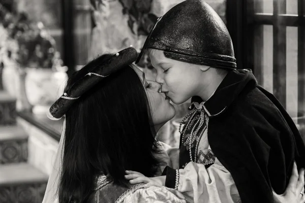 Mother and son kissing in medieval costumes