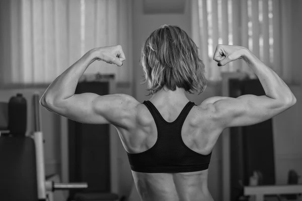 Woman shows her muscles