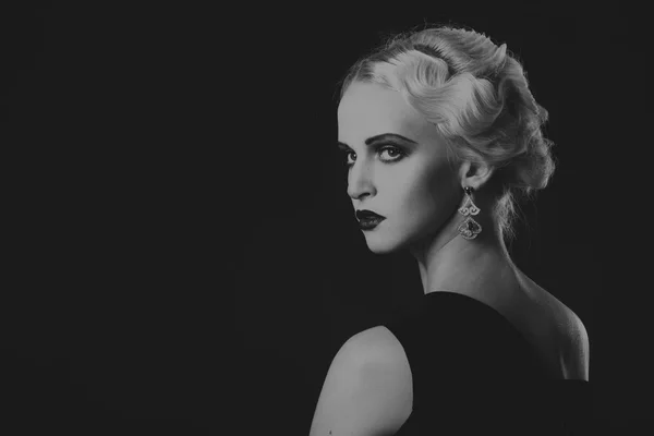 Beautiful blonde in vintage dress on a dark background