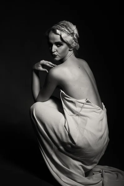 Beautiful blonde in vintage dress on a dark background