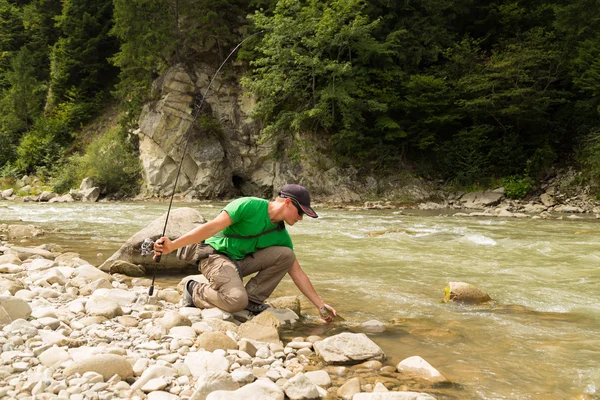 Fishing in the mountain river in summer