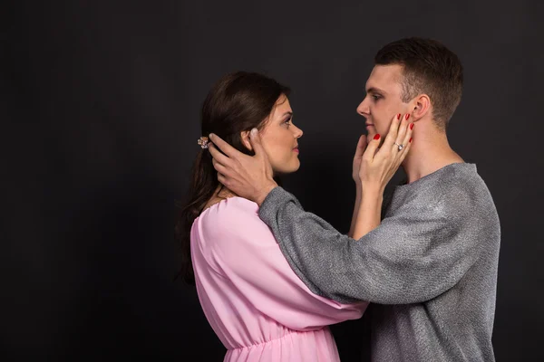 Young couple in love dancers on a dark background