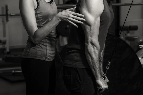 Young couple in the gym at the joint training