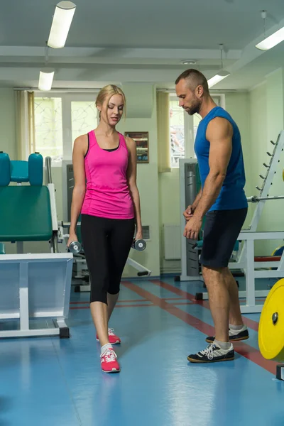 Young couple in the gym at the joint training