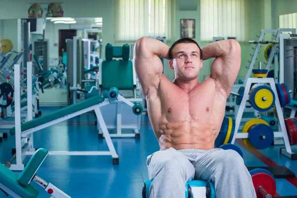 Grueling training professional bodybuilder in the gym.