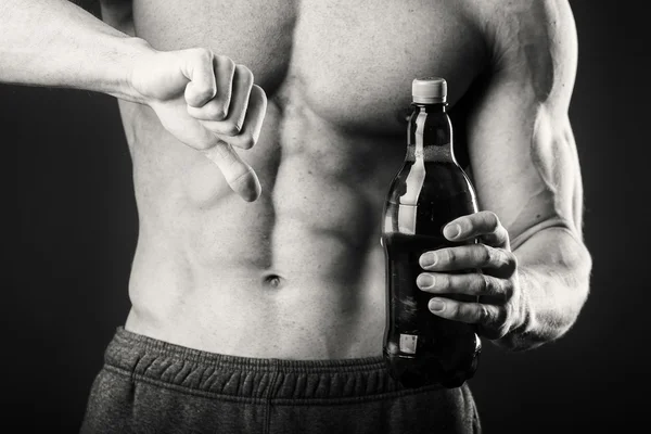 Male bodybuilder shows that beer is bad.