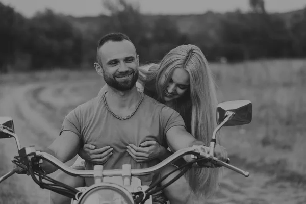 Happy couple traveling on a motorcycle.