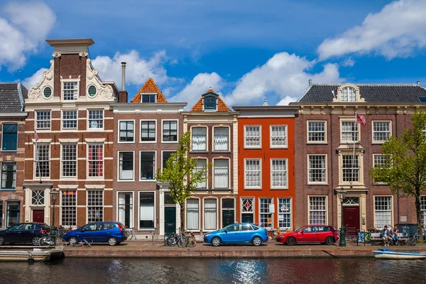 Houses and cars along the canal embankment in Leiden