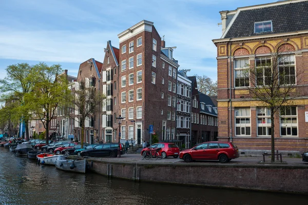 Houses and cars along the canal embankment in Amsterdam