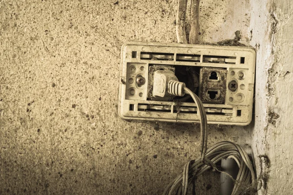 Close up of old plug on wall background