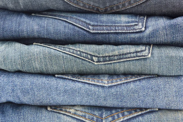 Close-up of a stack of folded blue jeans textured