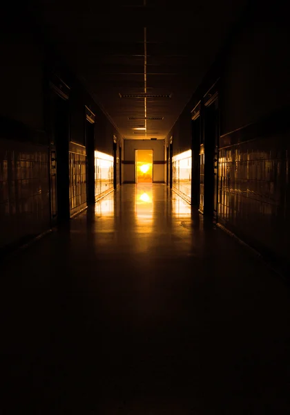 Dark corridor to sun at the door