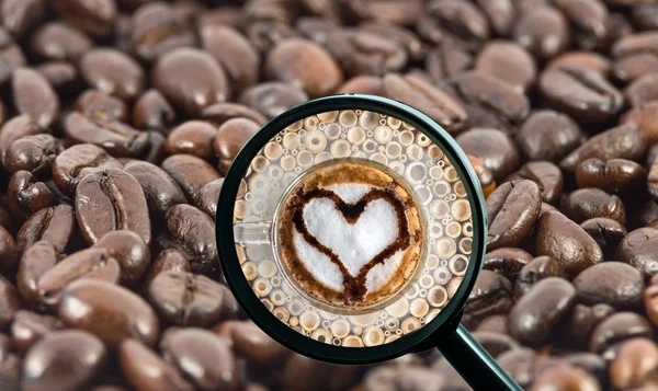 Magnifying glass with background of roasted coffee beans to be coffee cup with heart shape, food and drink with business concept
