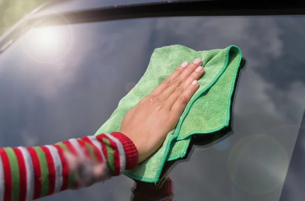 Human hand polishing car