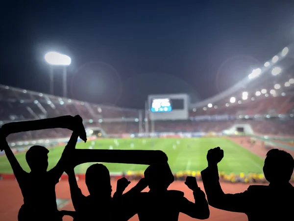 Silhouettes of football fans