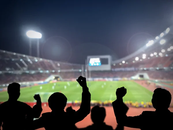 Silhouettes of football fans