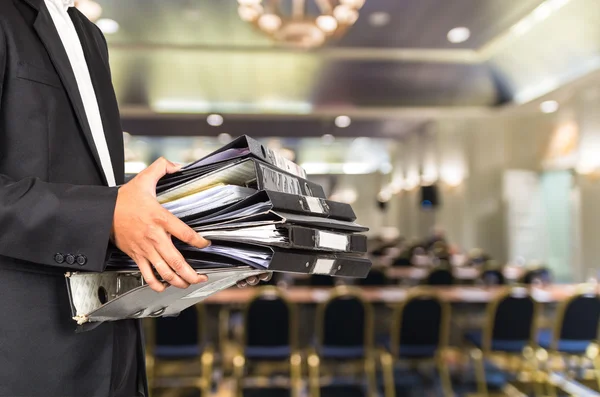 Businessman holding many document folders