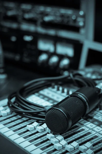 Close up of microphone with equipment on mixer