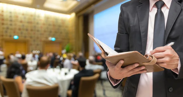 Businessman writing in note book