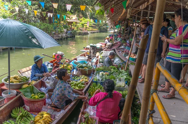 Merchant and customer on Wooden boats at Klong Lat Mayom Float Market on April 19, 2014 in Bangkok