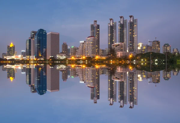 Bangkok cityscape reflect with lake at twilight time
