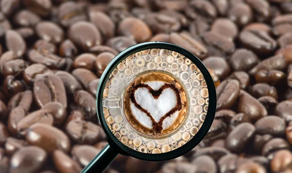 Magnifying glass with background of roasted coffee beans to be coffee cup with heart shape, food and drink with business concept