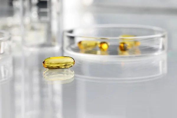 Vitamins pills omega 3 supplements with petri dish