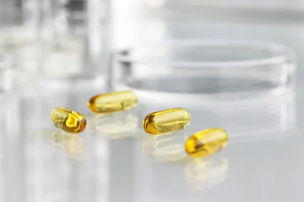 Vitamins pills omega 3 supplements with petri dish