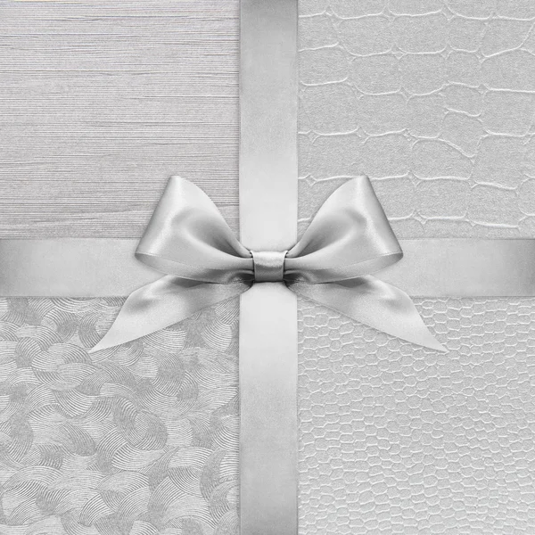 Shiny silver satin ribbon bow on argent background