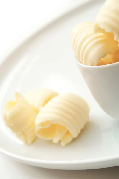 Fresh butter curls in dish