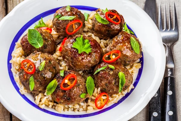 Homemade meatballs with wild rice, mint, green onions and chili sauce