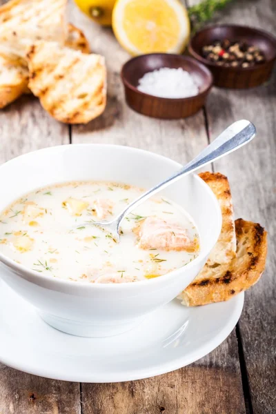 Homemade soup with salmon and cream with croutons